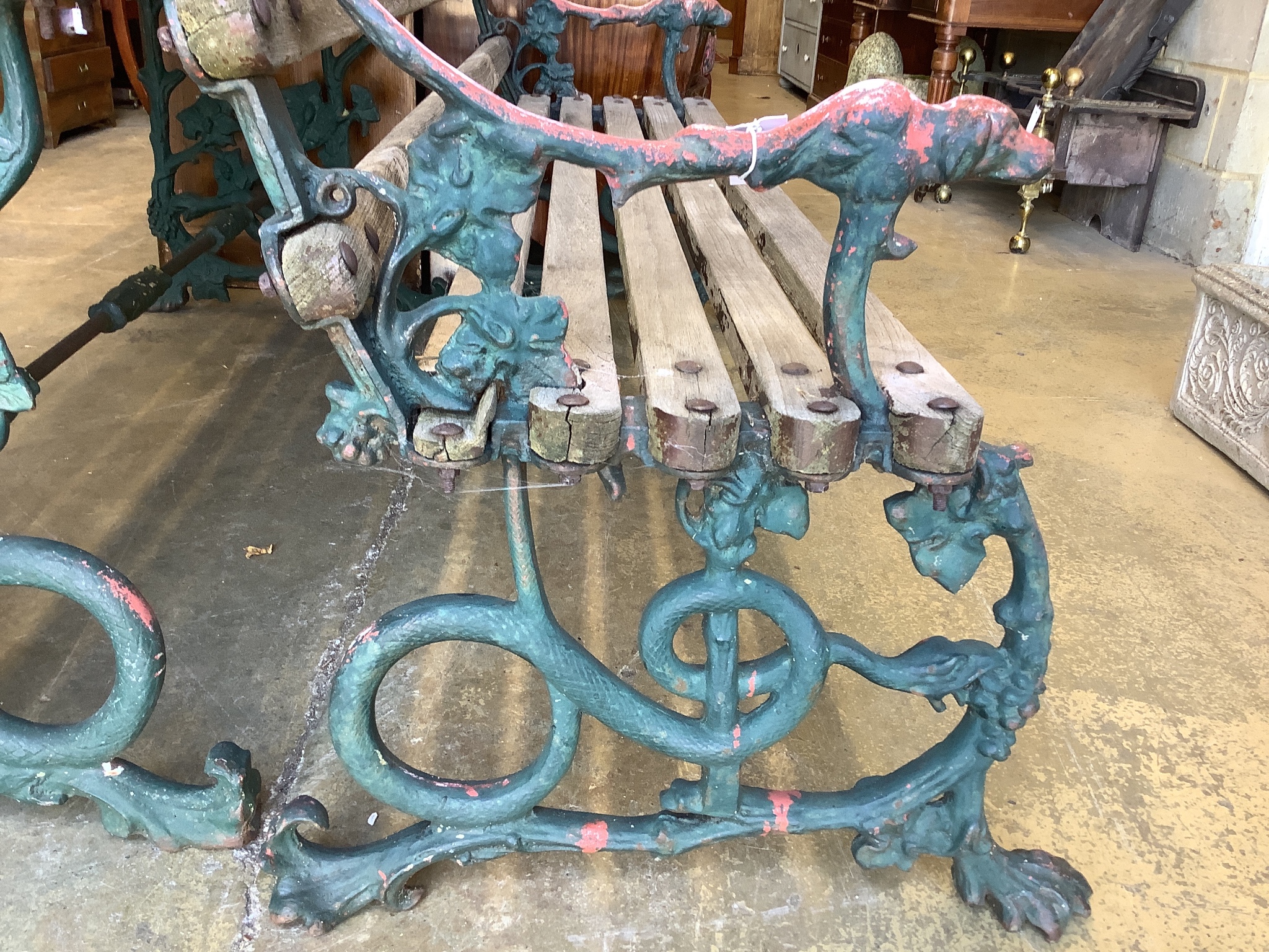 A Victorian Coalbrookdale painted cast iron Serpent and Grape pattern slatted garden bench and table, bench with cast hounds head terminals, table W-160, D-55, H-64, bench W-160, D-65, H-76cm.